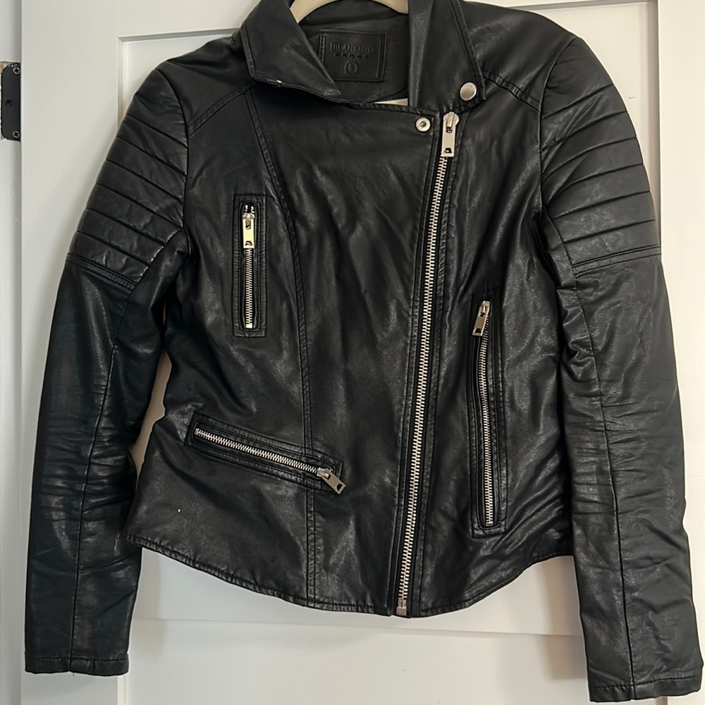 Small black BLANK NYC vegan leather jacket with zippers.